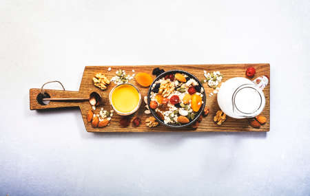 Muesli bowl, organic ingredients for healthy breakfast Granola, nuts, dried fruits, oatmeal, whole grain flakes on white background. Copy space, bannerの写真素材