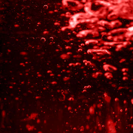 Red wine pouring background with bubbles Macro shotの写真素材