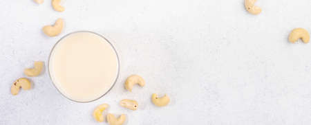 Vegan Cashew nut milk on white background. Non dairy alternative vegan drink. Healthy vegetarian food and beverage. Copy space, top viewの写真素材