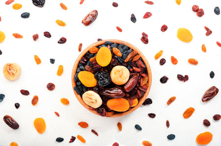 Healthy food snack: natural sun dried fruits mix in bowls on white background, top viewの写真素材