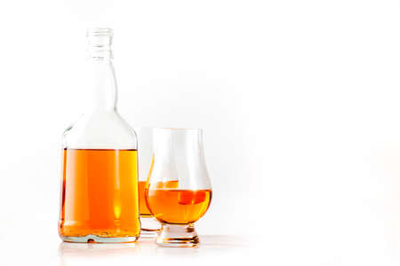 Scotch Whiskey in special glasses and bottle, white background with negative spaceの写真素材