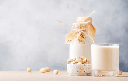 Cashew milk in bottles. Non dairy alternative vegan drink. Negative space