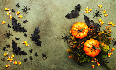 Happy Halloween swamp green background with pumpkins, bats, spiders, candy corn with copy space