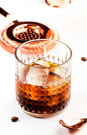 Black russian cocktail, trendy alcoholic drink with vodka, coffee liqueur and ice, white background,...