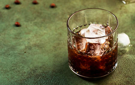 Black russian cocktail, trendy alcoholic drink with vodka, coffee liqueur and ice, rusty green dark backgroundの写真素材