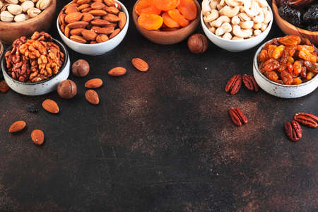 Nuts and dried fruits. Healthy snacks. Dried apricots, figs, raisins, pecans, walnuts, hazelnuts,...