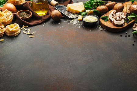 Italian uncooked pasta, brown champignons mushrooms, vegetables, cheese and ingredients for tasty...