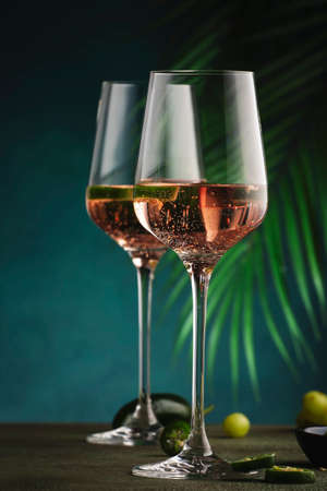 Rose pink wine with jalapeno pepper in wine glass, dark background, copy spaceの写真素材