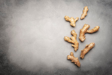 fresh ginger root. Gray kitchen table background, top view