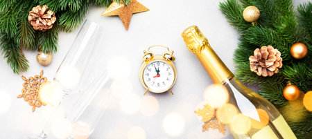 Christmas festive background with champagne bottle and wine glasses, golden christmas balls, alarm...