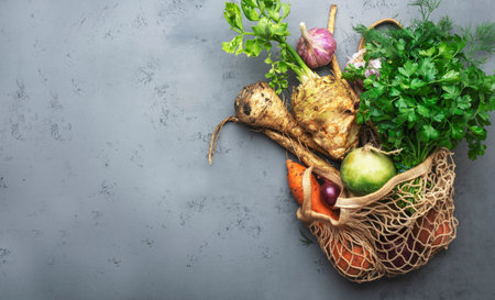 Autumn food background with vegetables, root crops in string bag: celery, radish, parsnips, carrots. Harvesting, local farm market shopping, healthy eating concept. top viewの写真素材
