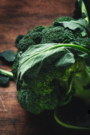 Fresh organic broccoli cabbage on old rustic wooden kitchen table background, top viewの写真素材