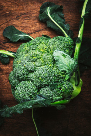 Fresh organic broccoli cabbage on old rustic wooden kitchen table background, top viewの写真素材