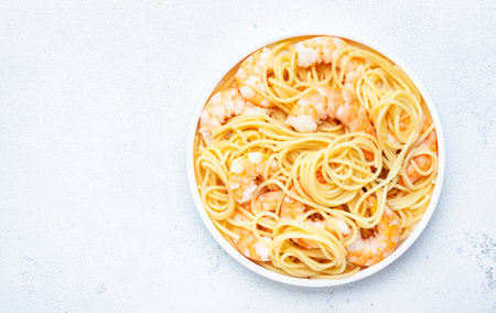 Spaghetti pasta with shrimp plate on white table background. top view, copy spaceの写真素材