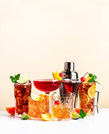 Summer cocktail drinks set: rum cola, long island ice tea, manhattan, cosmopolitan, old fashioned - popular beverages for cocktail party. Beige background, hard lightの写真素材