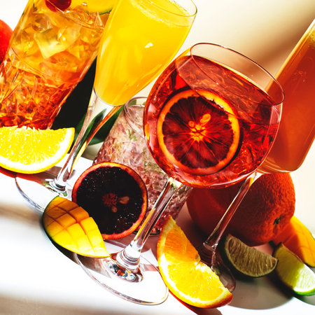 Summer alcoholic cocktails for party, refreshing drinks with sparkling wine, champagne, gin and rum. Beige background, hard light, shadow patternの写真素材