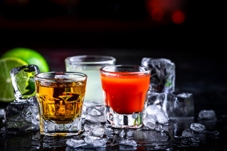 Tequila with sangrita and lime juice. Black bar counter backgroundの写真素材