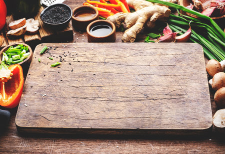 Food and cooking background. Wooden table with vegetables, spices and ingredients for preparing vegetarian Asian dishes with mushrooms and soy sauce. top view, copy spaceの写真素材