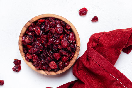 Organic sun dried cranberries in bowl on white background, top viewの写真素材