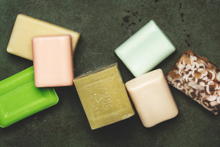 Bars of toilet moisturizing soap on green background, op view