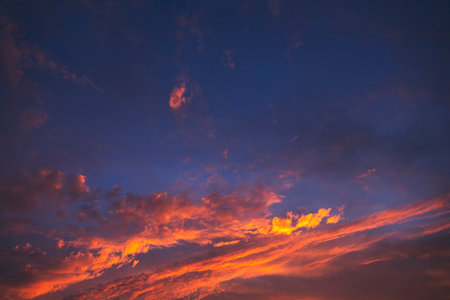 Stunning dramatic sunset sky with purple clouds and pink and red firmament textureの写真素材
