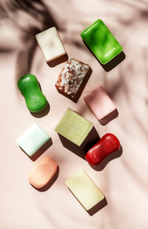 Set of colorful toilet moisturizing soap on pink background. Hard light, shadows, top viewの写真素材