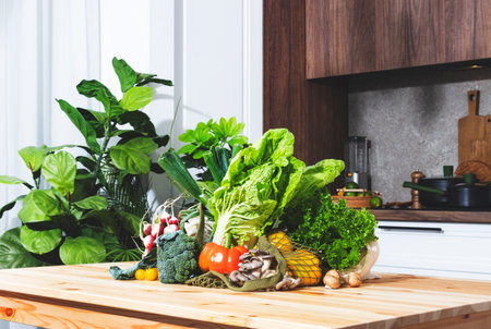 Colorful selection of vegetables and herbs from the farmers market arranged on a kitchen table for...