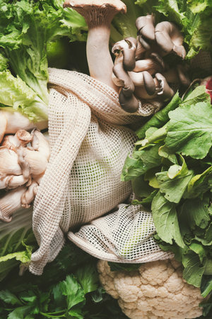 Green vegetables and herbs stored in an eco-friendly bag create a vibrant setting, ideal for...