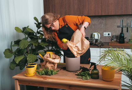Blonde woman showcasing her passion for gardening and home lifeの写真素材