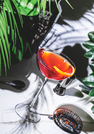 Hanky Panky cocktail with gin, vermouth, and herbal liqueur set against a lush green backdropの写真素材