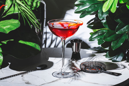 Hanky Panky cocktail features vibrant colors and an orange twist, complemented by stylish bar toolsの写真素材