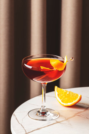 Classic revolver cocktail with bourbon and coffee liqueur at a stylish bar setting in the eveningの写真素材