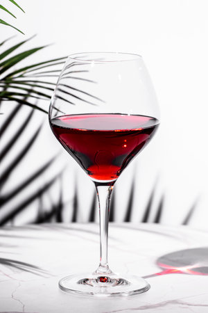 glass of red wine in a refined setting with elegant surroundings and a touch of sophistication