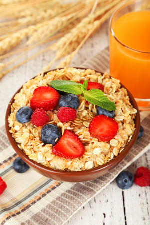 Oatmeal with berries on brown wooden backgroundの写真素材