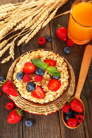 Oatmeal with berries on brown wooden backgroundの写真素材