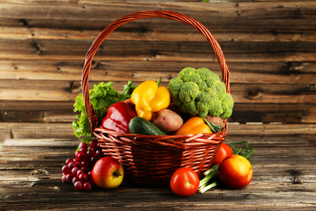 Vegetable in basket on brown wooden backgroundの写真素材