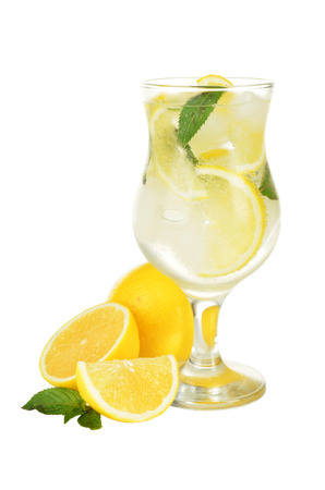 Lemons in a glass with water isolated on white の写真素材