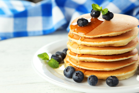 Delicious pancakes with blueberries on white wooden backgroundの写真素材