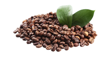 Coffee beans and leaves isolated on whiteの写真素材