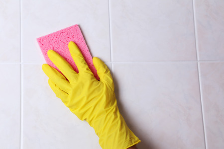 Cleaning kitchen tiles with spongeの写真素材