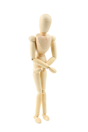 Wooden figure with stomach ache isolated on whiteの写真素材