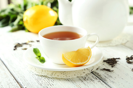 Green tea in cup and teapot on white wooden backgroundの写真素材