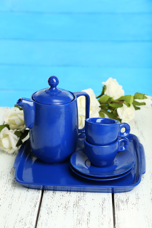 Teapot and cups on white wooden backgroundの写真素材