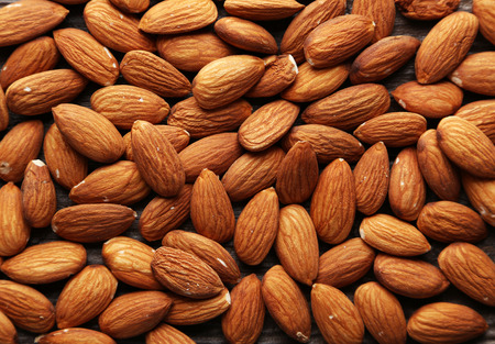 Almonds on brown wooden backgroundの写真素材