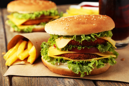 Big burgers on brown wooden backgroundの写真素材