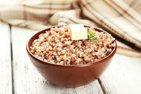Buckwheat in bowl on white wooden backgroundの写真素材