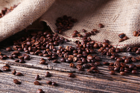 Coffee beans on brown wooden backgroundの写真素材