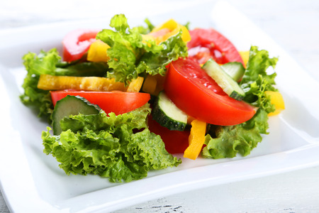 Fresh vegetable salad on white wooden backgroundの写真素材
