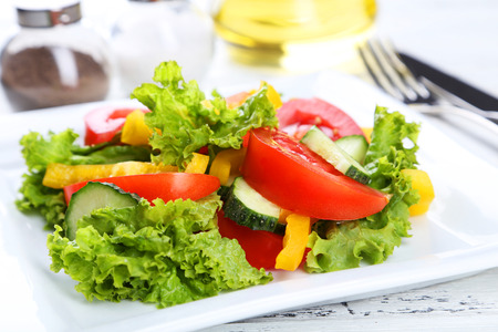 Fresh vegetable salad on white wooden backgroundの写真素材