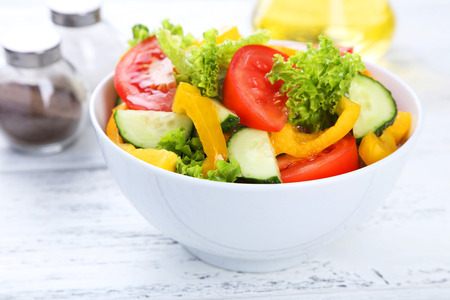 Fresh vegetable salad on white wooden backgroundの写真素材